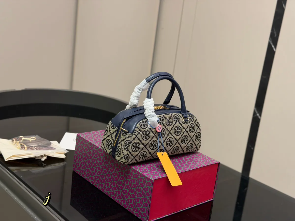 Tory Burch Monogram Handbag - 23 × 12 cm — source photograph 1 of 3